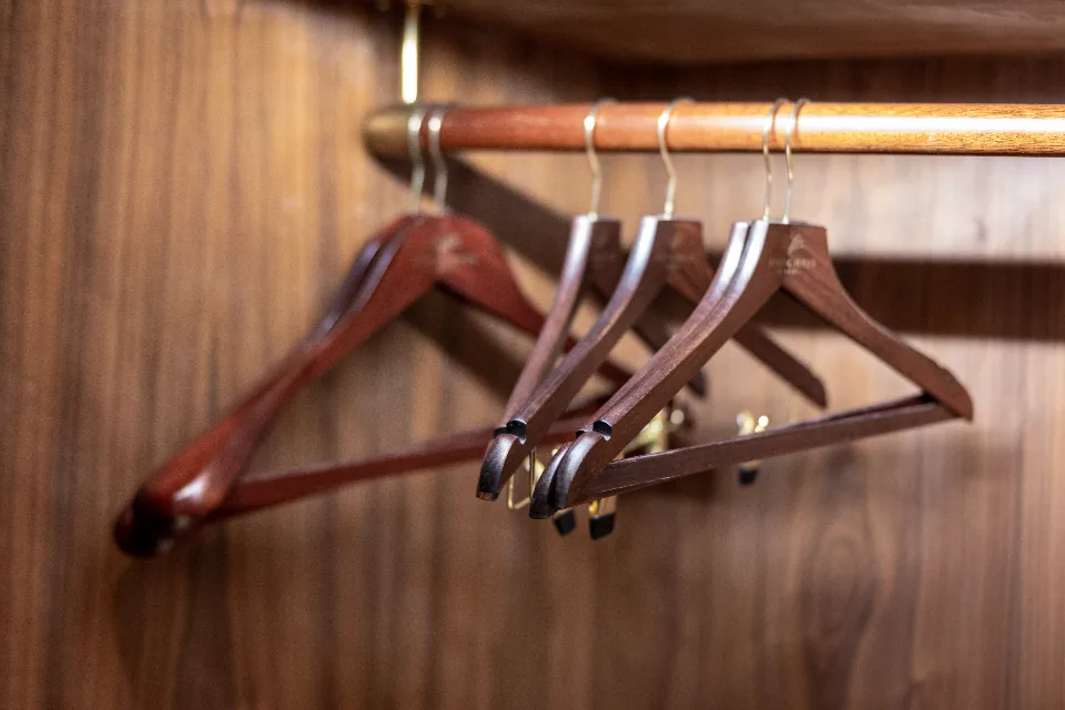Wooden hangers on a clothes rail