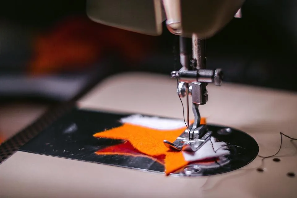 Sewing machine needle stitching fabric