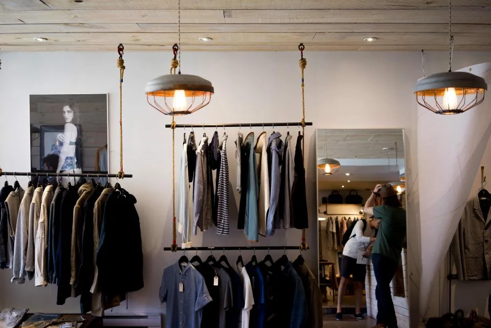 Clothing store interior with garments on rails