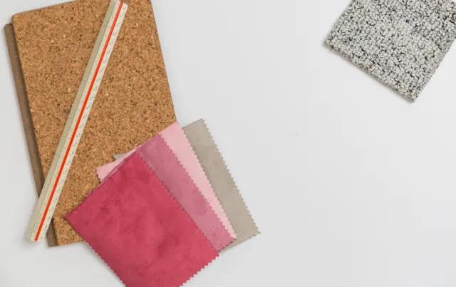 Fabric swatches on a cork board